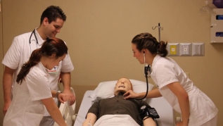 Students examining mannequin